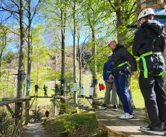 Luke Waldeck, second from right, waits his turn on the High Rope Walk in the tree tops of the Lake District 